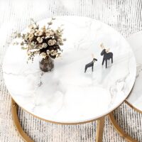 Pair of elegant marble tables with unique veining, featuring sleek metal bases.