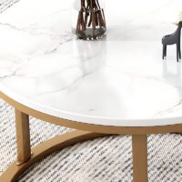Pair of elegant marble tables with unique veining, featuring sleek metal bases.