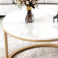 Pair of elegant marble tables with unique veining, featuring sleek metal bases.