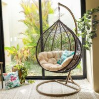 Cozy porch swing hammock made of durable, weather-resistant material, perfect for outdoor relaxation on a porch, patio, or garden.