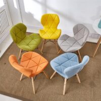 A Stylish Eames Dining Chair with a molded plastic seat and wooden legs, showcasing mid-century modern design.