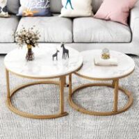 Pair of elegant marble tables with unique veining, featuring sleek metal bases.